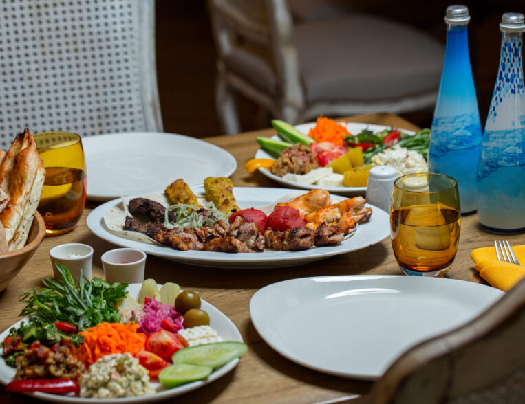 dining-table-donated-with-variety-foods-two-blue-bottles-mineral-water